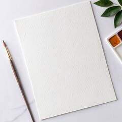 Blank watercolor paper sheet prepared for painting with brush and palette