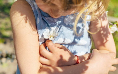 Child in a garden of flowering trees. Selective focus.