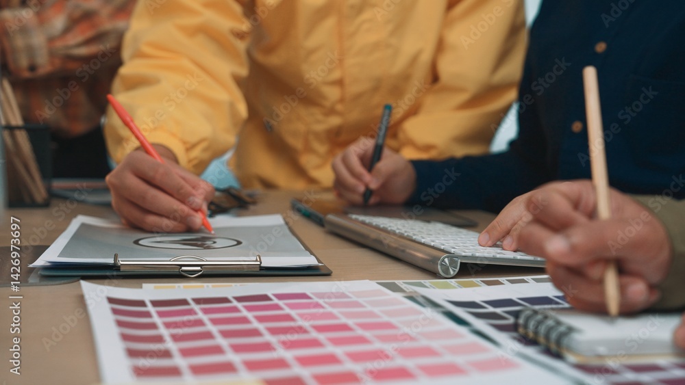 Poster a diverse team of professionals actively collaborates on a design project, using color swatches and 