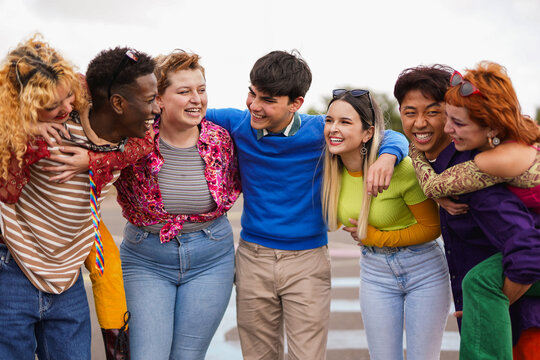 Group of diverse people having fun together outdoor - Multiracial young friends in the city - Social inclusion and friendship concept
