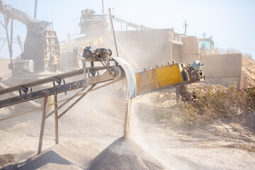 Crushing stones in a quarry for processing minerals, cement, limestone. Distribution and Screening Plant Gravel. Vibrating screen stone crusher in operation.
