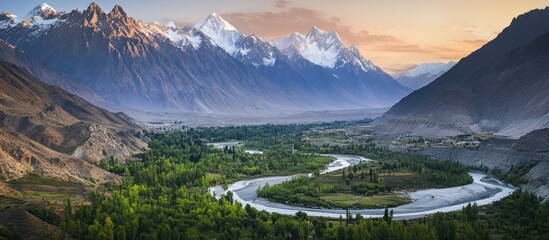 Fototapeta premium Majestic Mountain Valley River Winding Through Lush Landscape