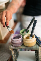 hands of a woman painting