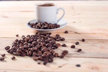  cup and coffee beans on old wooden table