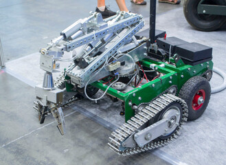 Small robot car unmanned with a crane and on tracks. Robotization robotics