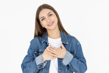 Smiling woman holding hands on chest. Isolated portrait.