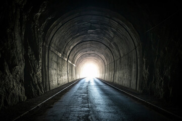 Obraz premium A dark tunnel with one light at its end - generated by ai