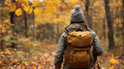 A person hiking in autumn foliage through a forest trail