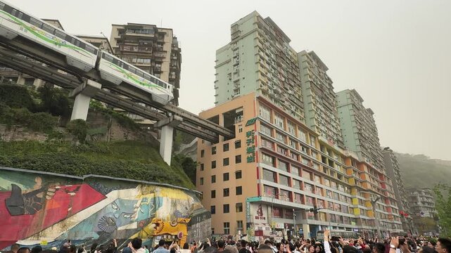 Chongqing, China - April 11, 2025: Popular train entering a building at Liziba Station in Chongqing, China