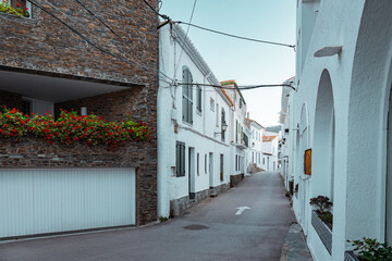 Narrow alley between white buildings in a historical residential area in Spain