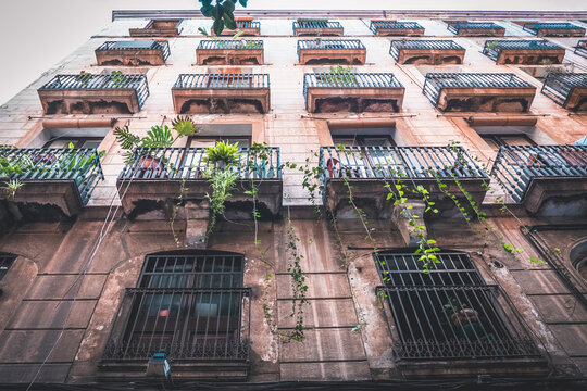 diminishing perspective of historic building facade with balconies in Barcelona, Spain. View up