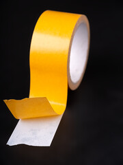 Double-sided tape stuck to the black surface.