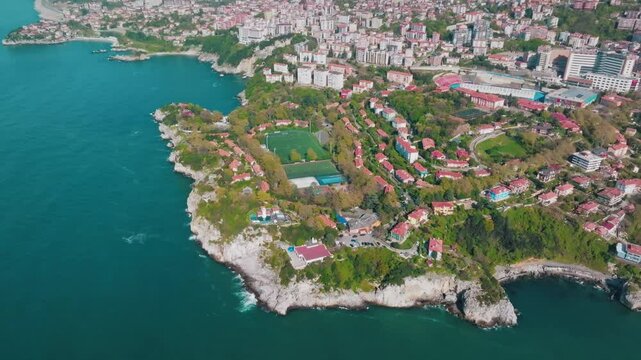 Drone footage circling an astroturf pitch near Fener Limanı, Zonguldak, showing both the pitch itself and the surrounding settlements and the impressive coastline of the Black Sea.