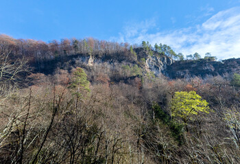the structure of the steep canyon walls, autumn walks along the canyon of the mountain river located in the gorge of the mountain range in cloudy weather