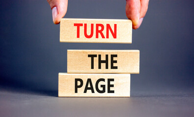 Turn the page symbol. Concept words Turn the page on beautiful wooden block. Businessman's hand....