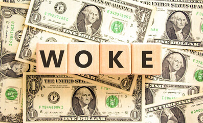 Woke question symbol. Concept word Woke question on beautiful wooden blocks. Dollar bills. Beautiful background from dollar bills. Business, lifestyle, support and woke question concept. Copy space.
