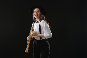 Naklejka premium Musician with soprano saxophone on dark background