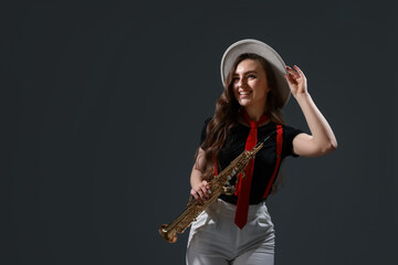 Fototapeta premium Musician playing soprano saxophone on grey background. Space for text