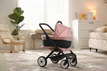Doll stroller in living room. Kid's toy