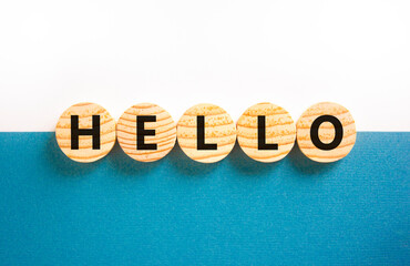 Hello symbol. Concept word Hello on beautiful wooden circles. Beautiful white and blue background....