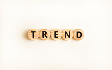 Trend and trending symbol. Concept word Trend on beautiful wooden circles. Beautiful white table white background. Business lifestyle trend and trending concept. Copy space.