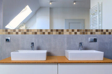 Modern bathroom interior with gray tiles and wooden decors