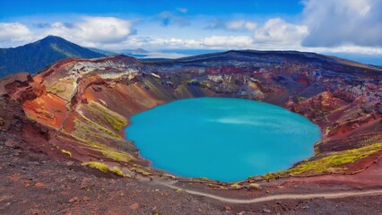 A vibrant blue crater lake nestled in a volcanic area with mountainous surroundings.