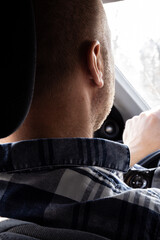 Man Driving a Car from Backseat View
