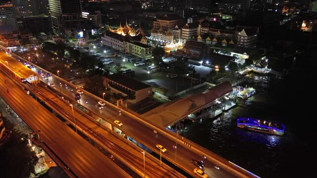 Aerial view of the Wat Yan Nawa temple in Sathon at night in the city of Bangkok, Thailand, 4k