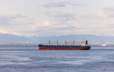Cargo Ship Crossing Near Port of Vancouver With Mountains and Skyline in View