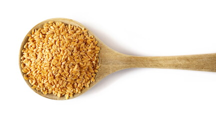 Organic golden flax seeds in wooden spoon, linseed grains isolated on white background, top view