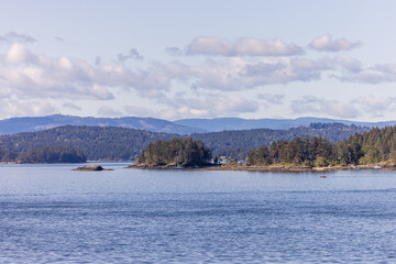 Scenic View of Gulf Islands Coastline with Trees and Hills in BC, Canada