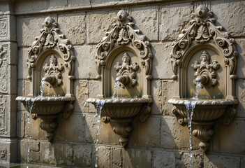 Exquisite Carved Stone Fountains with Flowing Water: Ornate Architectural Detail, Historical Craftsmanship, Tranquil Water Feature, Elegant Stone Carvings, Decorative Basins, Sculpted Floral Motifs, 