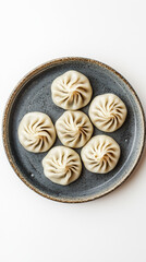 Fototapeta premium Traditional khinkali dumplings on rustic ceramic plate, top view.