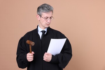 Judge with mallet and document on beige background