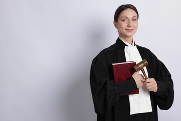 Judge with mallet on light background, space for text