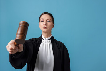 Judge with mallet on light blue background, space for text