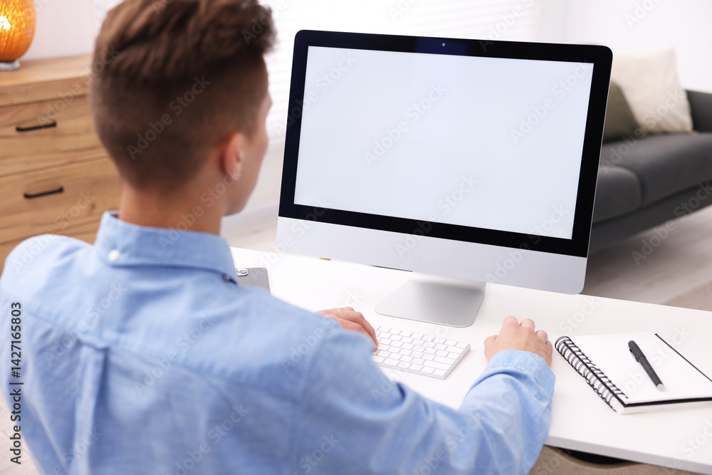 Poster man working on computer at white desk in office. mockup for design
