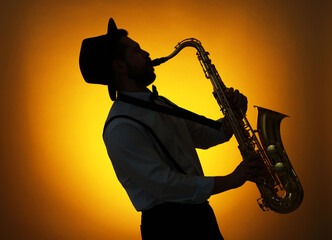 Professional musician playing saxophone on color background, backlit