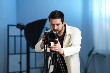 Man with professional video camera in studio