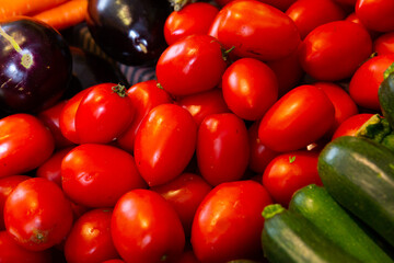 Harvest of ripe fresh tomatoes, displayed for sale in the store on the counter