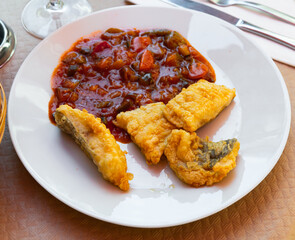Flour-fried cod fish served with ratatouille - Spanish fish dish
