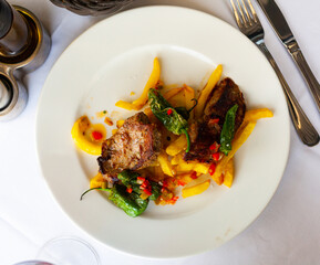 Delicious roasted veal served with fried potatoes and peppers