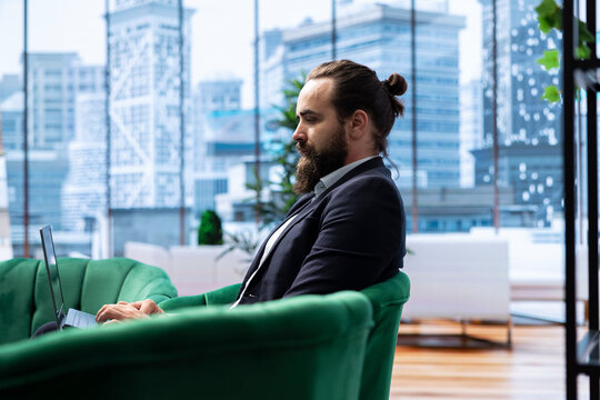 Goal oriented businessman focuses on his company and career development, analyzing reports and trends to ensure a success story in the competitive environment of business industry.