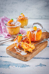 Traditional artisan carrot cake baked in glass jar with nuts and sugar frosting topping served as close-up on a wooden board