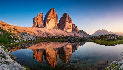 tre cime di lavaredo with reflection in lake at sundown dolomites alps © Mia