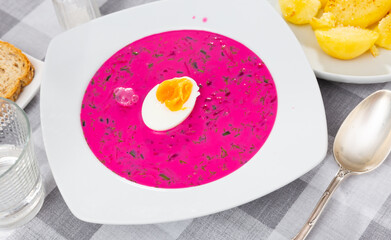 Popular dish of Belarusian cuisine is the summer vegetable soup Kholodnik, prepared on the basis of beetroot and decorated ..with sliced boiled egg on top