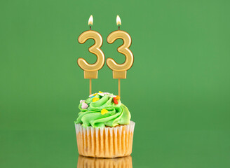 Birthday card with candle and cupcake - Number 33 on a green background