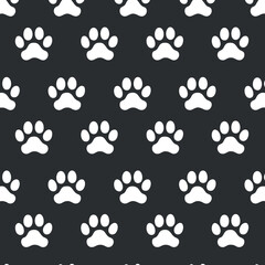 Seamless pattern featuring white paw prints on a black background suitable for various design projects.