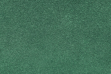 Fototapeta premium Grainy texture of asphalt, plaster, cement, plastic, rock, stone close up, macro. Background of green colored granular wall surface, rough backdrop